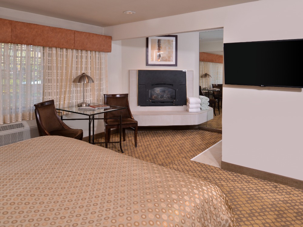 Hotel bedroom with one bed and fireplace