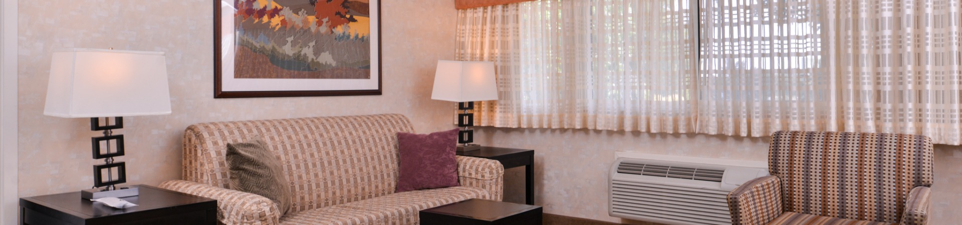 Hotel bedroom with sofa and chair